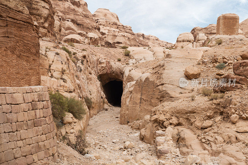 A manmade  drainage channel carved into a mountain in case of flood in front of the entrance to the gorge Al Siq in the capital of the Nabatean kingdom of Petra in Wadi Musa city in Jordan